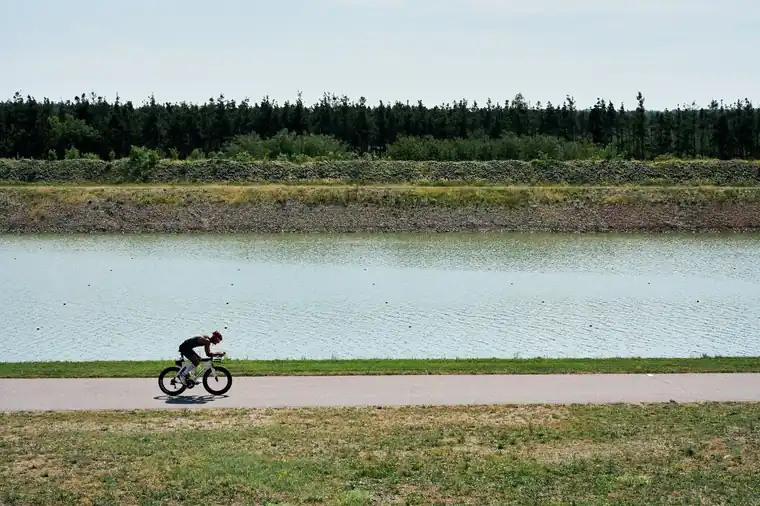 Cyclist on the flat course beside the canal